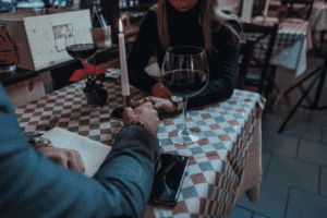 Elite professionals dating in a fancy restaurant while drinking wine