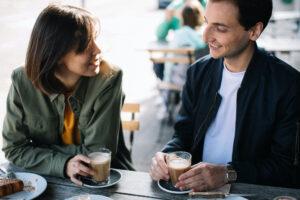 Man and woman dating over coffee while chatting