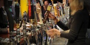 Woman barista serving beer
